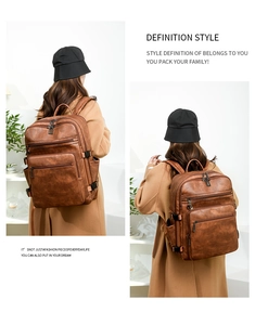 Brown leather backpack for women featuring multiple zipper pockets and side buckles