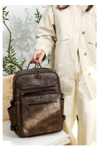 Detail of vintage brown leather backpack with multiple compartments and sturdy handle