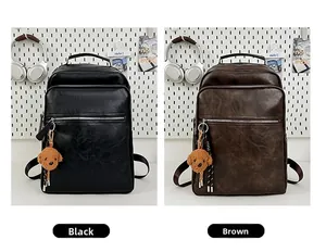 Close-up of retro PU leather backpacks in black and brown with cute teddy dog charms