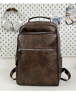 Detail view of deep brown vintage backpack with multiple zippered pockets and PU leather texture
