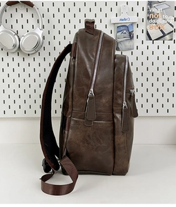 Side view of dark brown faux leather backpack featuring multi-pocket design and vintage texture