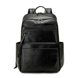 Minimalist black lychee texture backpack for women with tassel charm and multi-pocket design