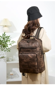 Classic dark brown PU leather backpack for business travel shown on female model
