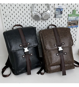 Classic leather backpacks in black and brown with metal buckles and flap design