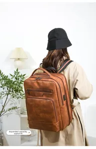 Brown PU leather travel backpack featuring expanded capacity and external USB charging port