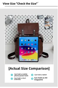 Spacious interior of vintage leather backpack compared with a tablet for size reference
