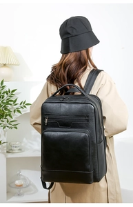 Close-up of black PU leather business backpack featuring multiple functional zipper pockets
