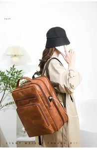 Close-up of brown PU leather business backpack with side USB port and expandable design