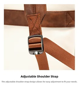 Detailed close-up of adjustable brown leather and nylon shoulder strap with metal buckle