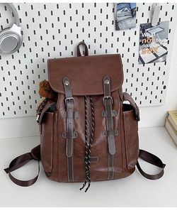 Detailed view of brown retro leather backpack with buckle straps and drawstring closure