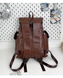 Brown vintage faux leather backpack with white stitching details and side pockets