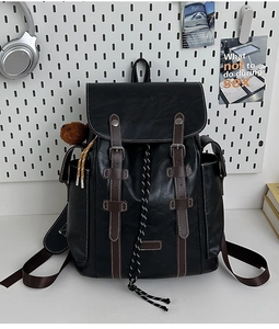Close-up of vintage black backpack with leather straps and silver buckles detail