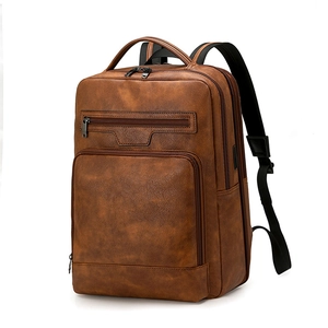 Detail view of vintage brown PU leather backpack showing multi-layer zippers and texture
