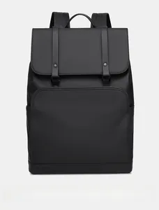 Front detail of minimalist black business backpack with waterproof coating and metal buckles