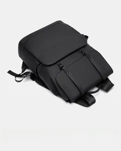 Top view of large matte black waterproof backpack with flap cover and buckle straps