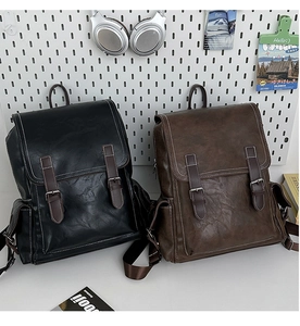Detail showing the retro PU leather texture and silver buckle straps on the backpacks