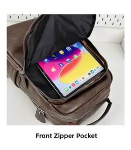 Front zipper pocket detail on dark brown vintage leather backpack showing storage for tablet