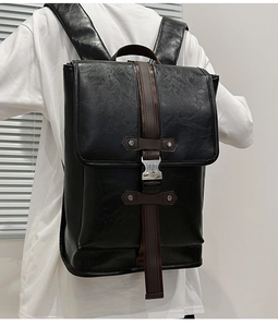 Back view of a large black vintage backpack featuring PU leather and brown straps
