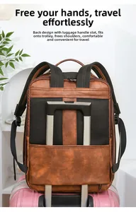 Brown leather business backpack with a luggage strap secured on a suitcase handle