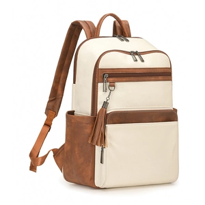 Detail view of two-tone PU leather backpack featuring tassel charm and multiple pockets