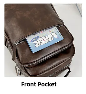 Detail of the front pocket on a brown leather backpack holding a blue spiral notebook