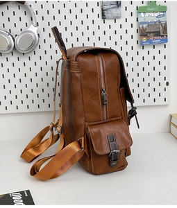 Detail view of brown vintage PU leather backpack with side pockets and metal zippers