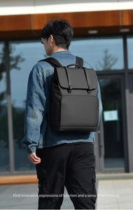 Minimalist black waterproof business backpack with flap cover and metal buckle details