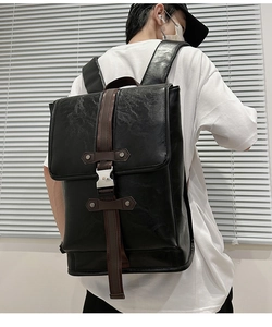 Rear view of black PU leather backpack showing wide shoulder straps and large capacity
