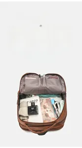 Internal view of brown PU leather backpack showing large capacity and multi-pocket storage