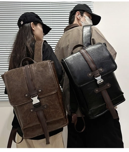 Rear view of two models wearing vintage brown and black PU leather backpacks with metal buckles