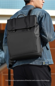 Minimalist black matte business backpack with double buckle flap design on model