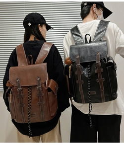 Detailed view of vintage leather backpacks in black and brown with metal buckles