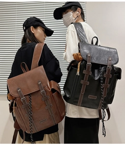Detail view of retro large-capacity backpacks in brown and black with leather texture
