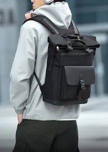 Rear view of a man carrying a breathable black tactical backpack in a modern urban setting