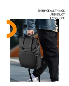 Detail of minimalist black business backpack with leather-like texture and flap closure