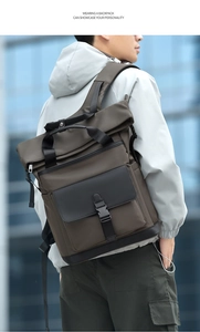 Detail of waterproof brown and black business backpack with leather trim and wide straps