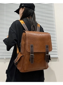 Close-up detail of British retro PU leather backpack with vintage metal buckles and stitching