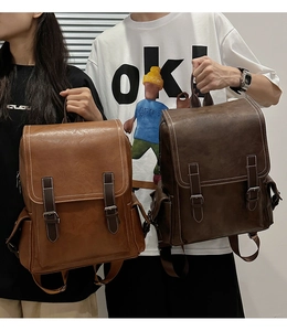 Detail view of vintage PU leather backpacks in light brown and dark coffee colors
