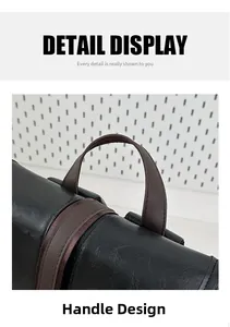 Detail view of the durable brown leather handle and neat stitching on a black backpack