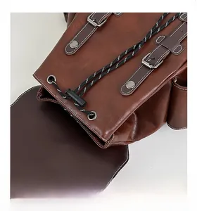 Detail view of adjustable metal buckle and drawstring closure on brown leather backpack