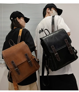 Detail of vintage leather backpack showing high-quality stitching and buckle closure