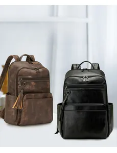 Detail shot of brown and black leather backpacks with tassel accents and multiple pockets