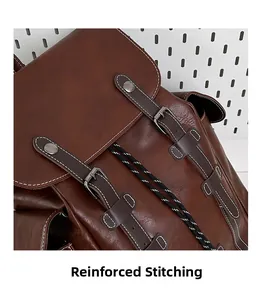 Detail of vintage brown backpack showing reinforced stitching and heavy-duty buckles