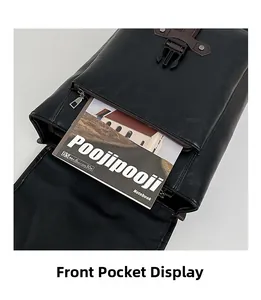 Detailed close-up of the black PU leather backpack front pocket with a B5 notebook
