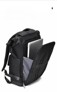 Detail view of the dedicated laptop compartment showing a silver notebook in the backpack