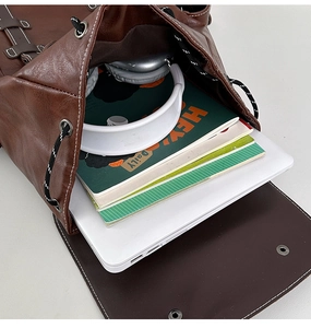 Macro view of vintage brown leather backpack interior showing spacious laptop storage space