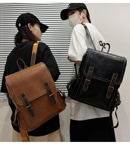 Dual model display of vintage leather backpacks in brown and black for outdoor travel