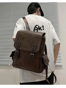 Detail of vintage brown leather backpack with contrast stitching and side pockets