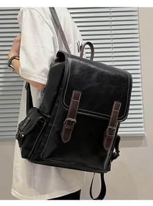 Close-up of vintage PU leather backpack featuring brown contrast straps and white stitching