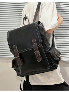 Detail of vintage PU leather backpack with contrast stitching and metal buckle closures
